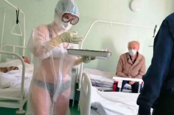 A nurse at a hospital in Tula, Russia, wore nothing but underwear beneath a see-through protective suit, gloves and goggles while working in a COVID-19 ward.