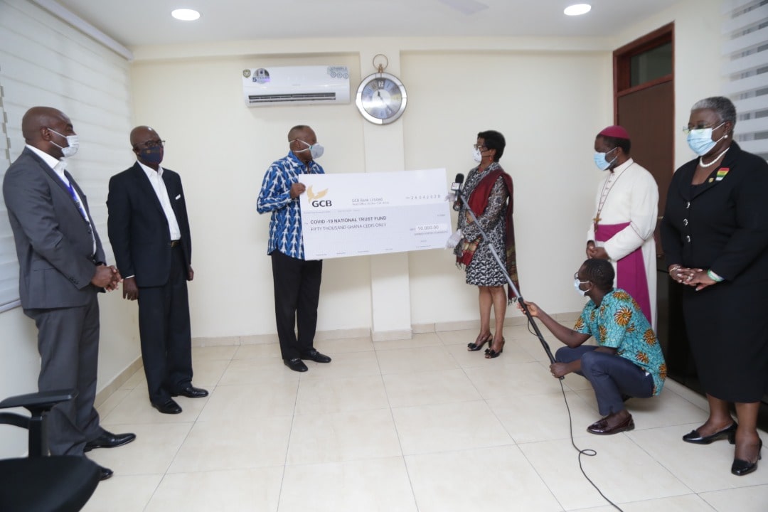 Mrs Sophia Akuffo (right), Chairperson, Covid-19 Trust Fund receiving a cheque for Ghs50,000 from Mr Nick Amateyefio (3rd left), Chairman, Dannex Ayrton Starwin. With them are management members of the company.