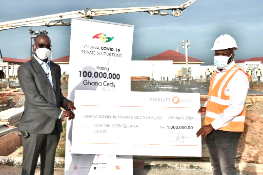 Mr Julian Kingsley Opuni (left) presenting the cheque to the contractor