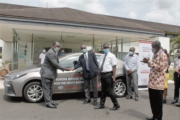 Mr Jacob Pimpong  (2nd left) presenting the  keys to the car to Prof. Kwabena Annan. Picture: Maxwell Ocloo