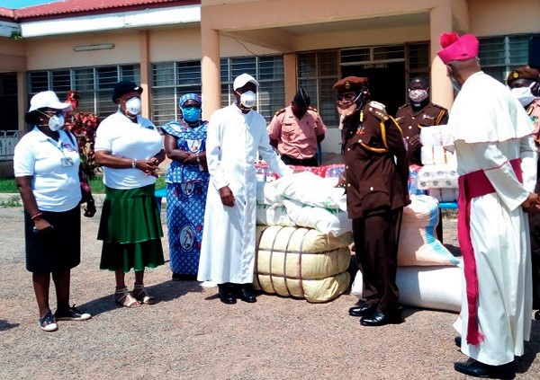 Rev. Fr Gyasi (3rd left) presenting the items to Mr Dominic Arthur 