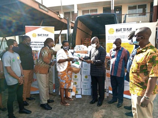 Ms Josephine Mukakalisa (4th left), handing over the educational materials to Professor Opoku-Amankwa (4th right), while other dignitaries look on