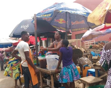 A seller and buyer engaged in a conversation without nose masks