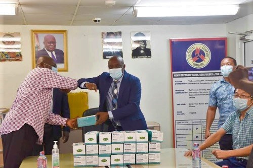 Nana Obokomatta II (left) presenting the masks to Mr Kwame Agyemang-Budu 