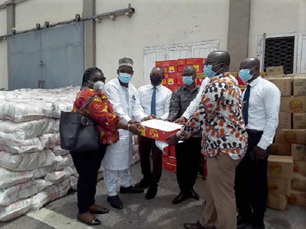 Mr Osei Assibey Antwi (right) receiving the items from Mr Samuel Appiah (3rd left) who is being supported by Mr Abubakari Wumbei (2nd left)
