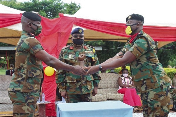 Lt Col William Anyimiah Kobby Ackah (left) handing over to Lt Col Obiri-Yeboah while Brig Gen Joseph Aphour looks on