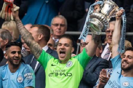Ederson and Bernardo Silva of Manchester City with FA trophy during the FA Cup Final match between Manchester City and Watford at Wembley Stadium on May 18, 2019 in London, England