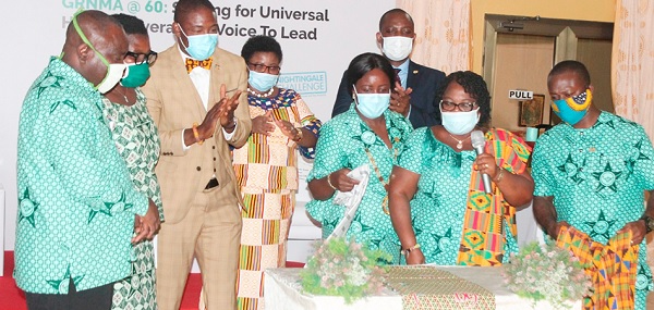Mrs Perpetual Ofori-Ampofo (3rd right) being supported by Mrs Alice Darkoa Asare-Allotey (2nd right), former President, GRNMA to unveil the GRNMA 60th anniversary cloth. Also in the photograph is Dr Bernard Okoe-Boye (3rd left).