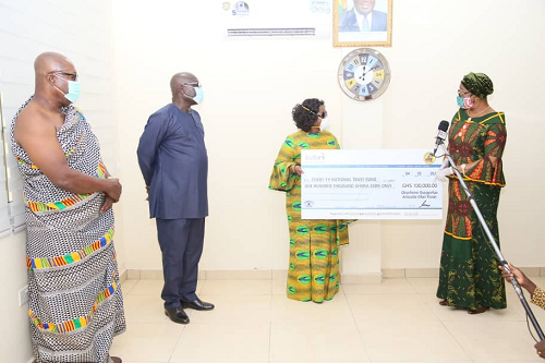 Mrs Sophia Akuffo,Chairperson ,National Covid-19 Trust receiving a cheque for ghc100,000 from Nana Asabea Ofori Atta,wife of Okyehene Amoatia Ofori Panin. Picture:Samuel Tei Adano