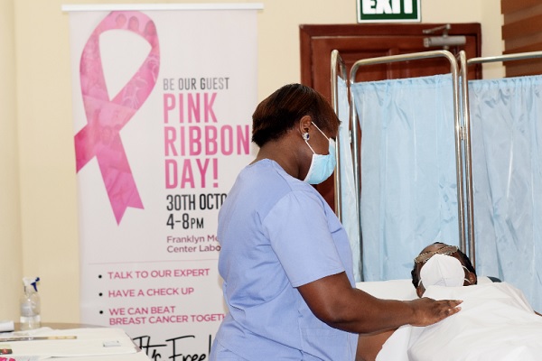 Dr Mawusi Kemetse examining the breasts of a Graphic staff