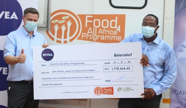 Mr Olivier Bodson (left), Country Manager of Beiersdorf CWA, presenting the cheque to Mr Elijah Amoo Addo, Founder and Executive Director of FFAA 