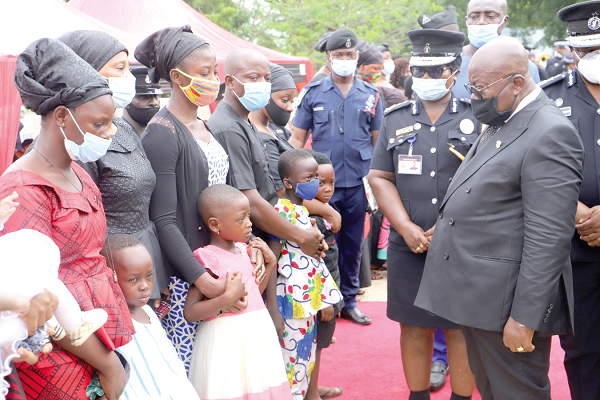  President Akufo-Addo commiserating  with some widows and children of the late policemen who fell in the line of duty. Picture: SAMUEL TEI ADANO