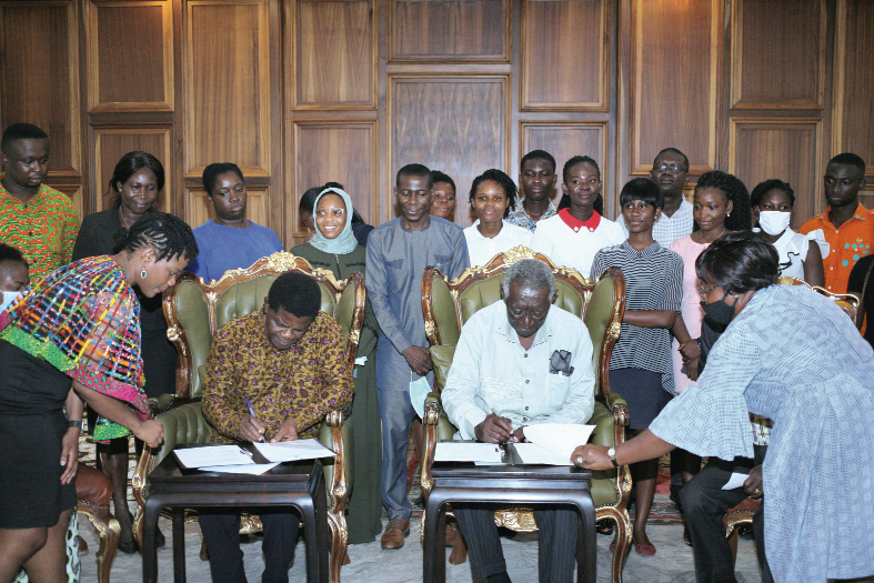 Former President John Agyekum Kufuor (2nd right) Chairman, JAK Foundation, and Mr Kwaku Ansa-Asare (2nd left), Founder, MountCrest University College (MUC), signing the memorandum of understanding. Looking on are Mrs Irene Ansa-Asare Horsham (left), Rector, MUC, staff members of MUC, and some students of the Kufuor Scholars Programme. Picture: Maxwell Ocloo