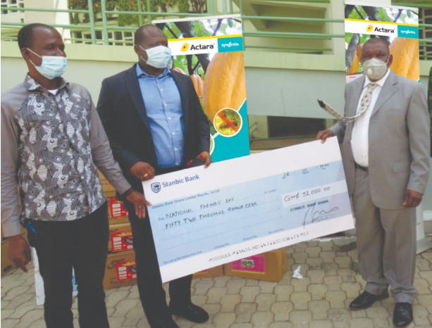 Presenting the cheque are Mr. Imoro Sulemana, Acting CEO of African Tiger Holding/Overseas Warehouse Ltd. and Mr. Busia Dawuni, Managing Director of IWAD Ghana Ltd. while Dr. Nurah Gyele, Minister of State at the Ministry of Food and Agriculture receives it on behalf of the Ministry.