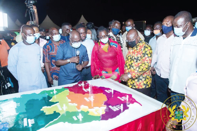 President Akufo-Addo seeking clarification on the project. Those looking on include Mrs Ursula Owusu Ekuful (4th left), the Minister of Communications