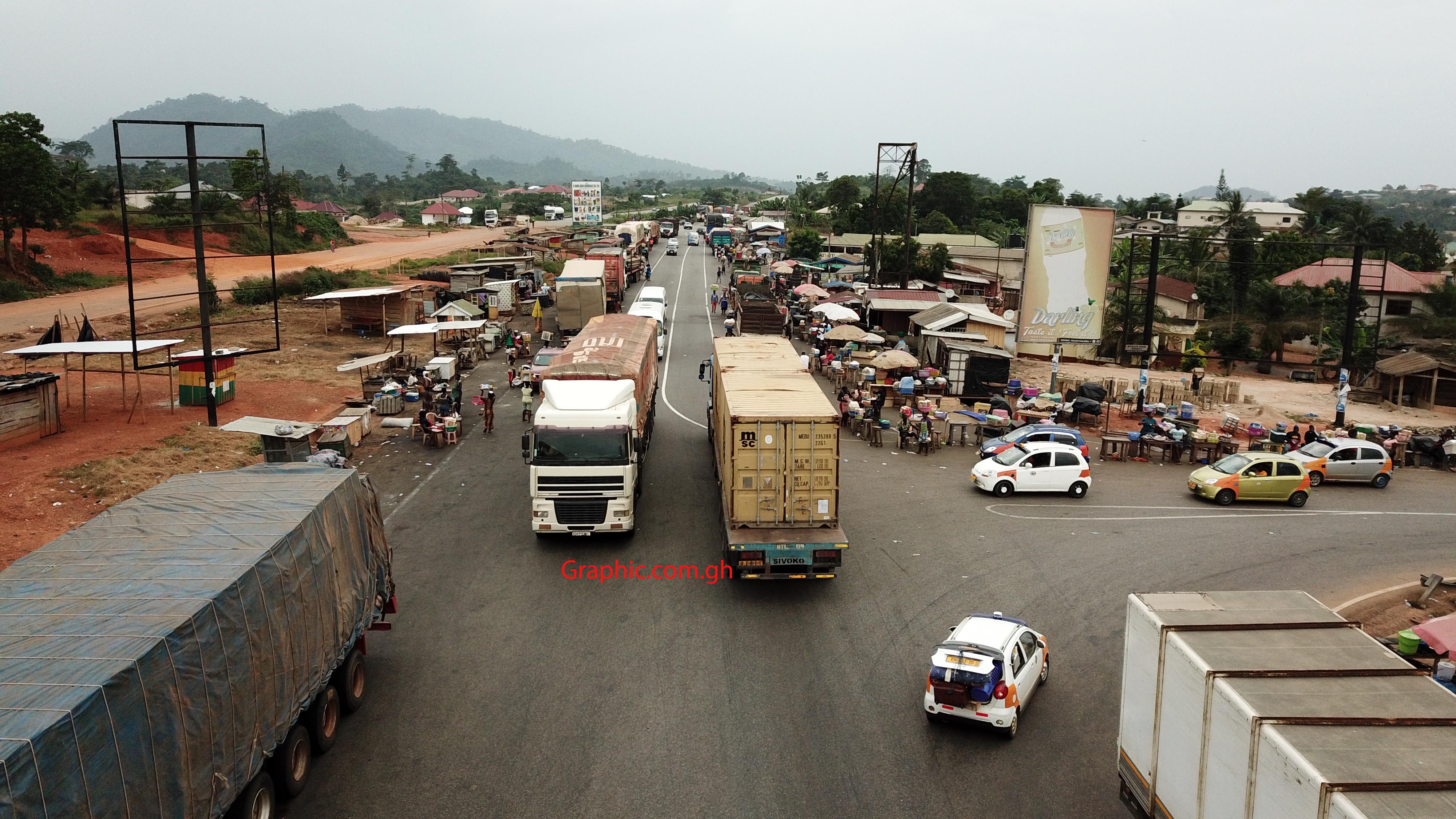Trucks parked on both shoulders of the Nkawkaw road. Picture: Douglas Anane Frimpong 