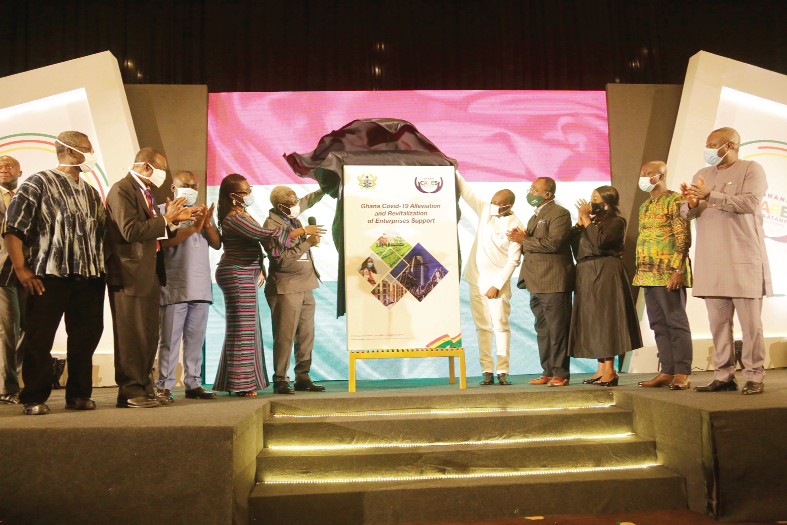 Mr Yaw Osafo-Maafo (5th left), the Senior Minister, being assisted by Mr Ken Ofori-Atta (5th right), the Minister of Finance, and other government officialls to unveil the Obaatan Pa programme logo. Picture: NII MARTEY M. BOTCHWAY