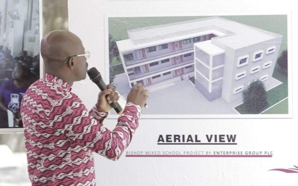 Chief Executive Officer of the Enterprise Group, Keli Gadzekpo displaying an aerial view of the proposed school block