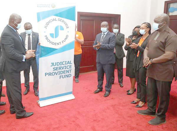 Justice Paul Baffoe-Bonnie (5th right), a Justice of the Supreme Court, Ms Cynthia Pamela Akotoaa Addo (3rd right), the Judicial Secretary, and other officials applauding after Chief Justice Kwasi Anin Yeboah (left)  had unveiled the logo in Accra. Picture: GABRIEL AHIABOR