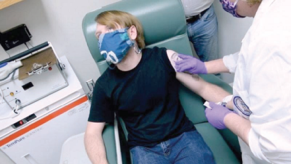 A vaccine trial participant being injected in Baltimore in May