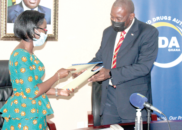 Mrs Delese Mimi Darko and Mr Pedro Despaigne Gonzalez exchanging the signed documents