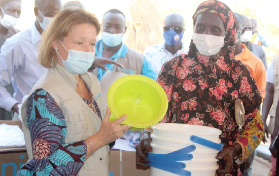 Ms. Anne-Claire Dufay (left), country representative of UNICEF, presenting the items to one of the victims