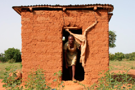  Esther Dagawie comes outside her latrine in Lambussie