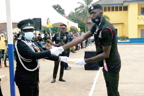 G/Constable Samuel Addo Ohene (right) picking the Overall Best Recruit prize from COP Kwasi Mensah Duku, the Ashanti Regional Police Commander 