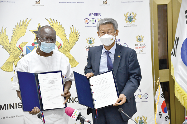 Mr Ken Ofori-Atta (left) and Ambassador Kim Sungsoo displaying the documents after signing the 2020-2021 framework arrangement between the Government of Ghana and the Government of the Republic of Korea. Picture: EBOW HANSON