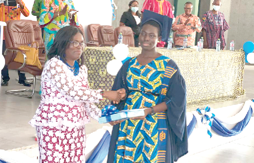 Ms Doris Akosua Aku presenting the Overall Best Student award to Ms Avanida Maafia Amoah Birikorang