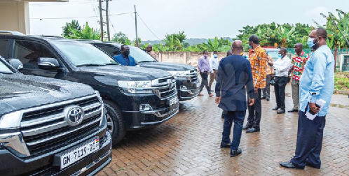 Dr. Matthew Opoku Prempeh (right) joins others to inspect the vehicles