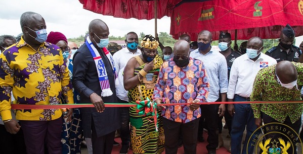 President Akufo-Addo being assisted by the Mansohene, Obrempong Sintim Poku, to cut the tape to inaugurate the facility.