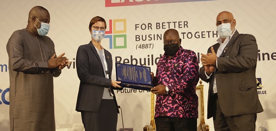 President Akufo-Addo receiving an award from Ms. Silke Hollander (2nd left), Deputy Resident Representative of the  UNDP to Ghana. With them is Dr. Mohammed Awal