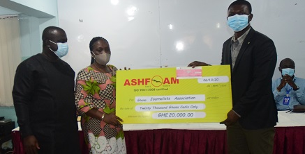 Mr. Nana Yaw Amped-Darko Antwi (right) presenting the cheque for GH¢20,000 to Ms. Linda Asante-Agyei. Looking on is Mr. Albert Dwumfuor (left), Organising Secretary of GJA. Picture: ALBERTA MORTTY