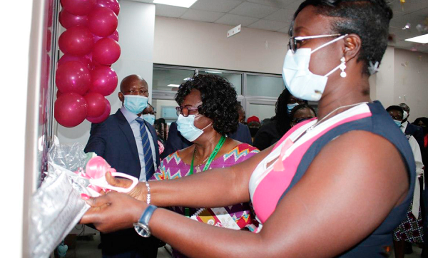 Ms Sandra Opoku (right), Director of Tema Port, opening the unit, while Mr Michael Luguje and Dr Martha Gyansa-Lutterodt (in suit) look on