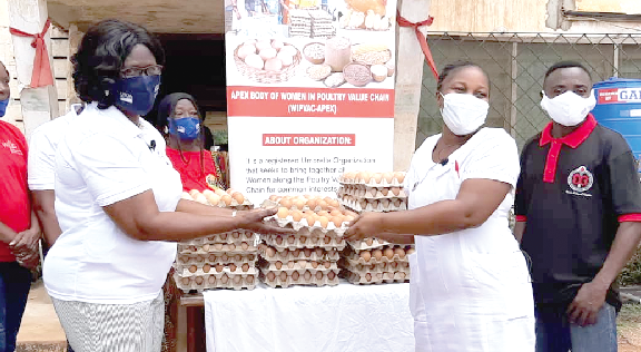 Mrs. Victoria Norgbey (left) presenting some of the eggs to Ms. Beatrice Danso of the Pantang Psychiatric Hospital