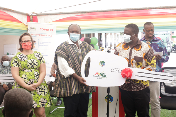 Mr Derek Owusu-Ansah (right), Project Manager of TEDMAG, presenting a symbolic key to the buses (inset) to Mr Patrick Robert Ankobeah, with Ms Stephanie Brunet (left) looking on. Picture: NII MARTEY M. BOTCHWAY