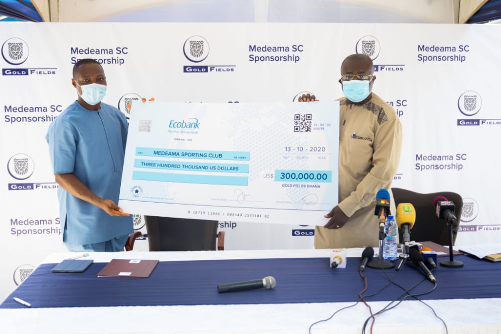 Dr Toni Aubyn (right) and Mr Alfred Baku displaying a dummy cheque