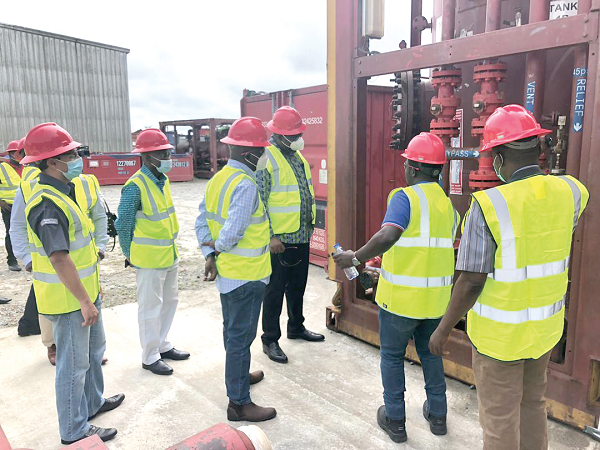 Mr E. Asante (2nd right), an engineer, briefing the team on the operations of the separator equipment