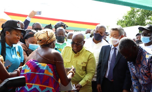 President Akufo-Addo (3rd right) handing over an improved charcoal stove to Manye Angmorkuor Yoko I (back to camera), a Development Queen Mother of Manya Krobo, at the ceremony in Akuse. Picture: GABRIEL AHIABOR