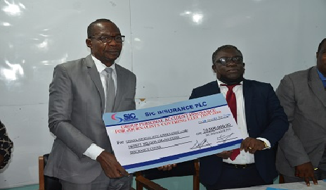 Mr Affail Monney (left) and Mr Faris Attrickie (right) displaying the dummy cheque after the signing ceremony