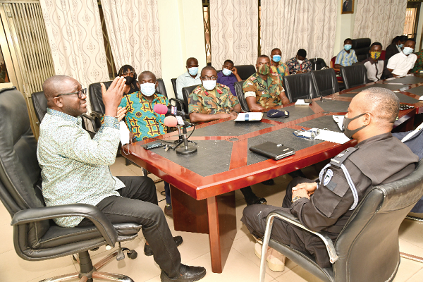  Mr George Sarpong (left), the Executive Secretary of the NMC, explaining how the software for monitoring Election 2020 works. Picture: EBOW HANSON