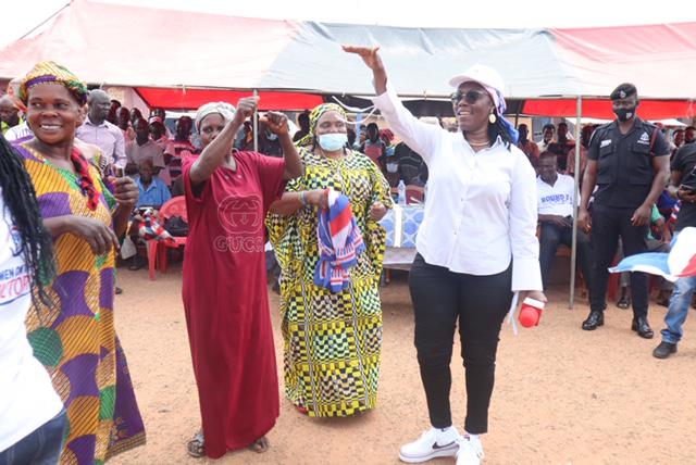 Mrs Owusu Ekuful (right) with supporters of the ruling party during her visit