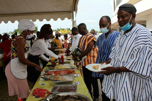 Mr Salifu Saeed, ( In white and black smock)the Northern Regional Minister  and Dr Bambangi ( in blue and white smock), a Deputy Minister of Food and Agriculture sampling some of the pastries and food prepared with egg at one of the stands at the exhibition 