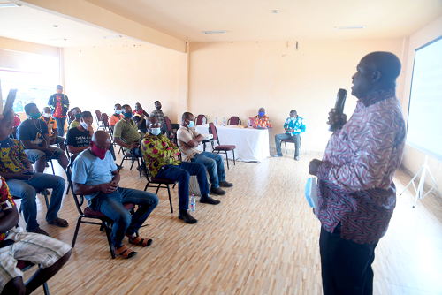 Mr Samuel Nii Adjei   Tawiah (right) addressing the participants