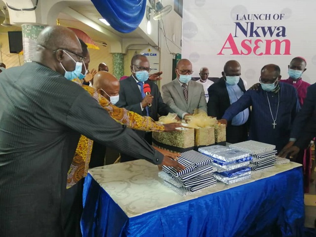 The members of the KCCC and Biblica praying over the Nkwa Asem before the launch