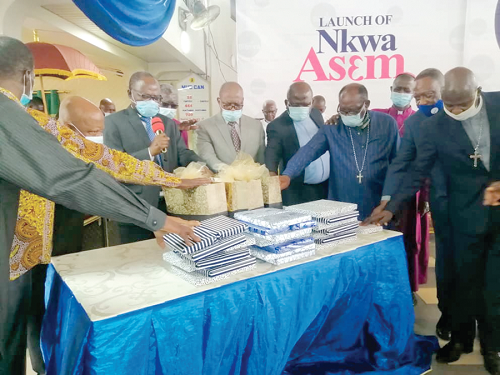 The members of the KCCC and Biblica praying over the Nkwa Asem before the launch