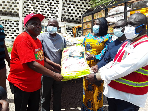 The Managing Director of the NEDCo,Mr Osman Ayuba(second right) and the Upper East Regional Minister, Miss Tangoba Abayage (third right) with support from some officials of the NADMO and the Pwalugu Multipurpose dam making a symbolic presentation of the relief items at a short ceremony at Bolgatanga.