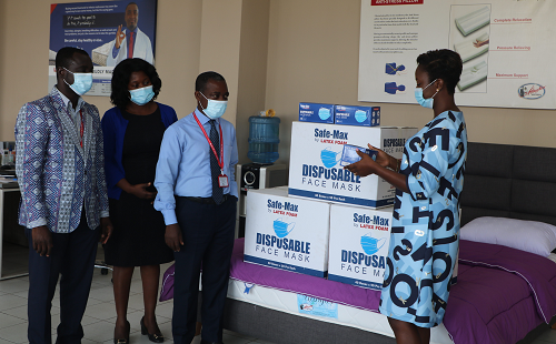 The Public Relations Officer (PRO) of Latex Foam, Mrs Gifty Ekeocha Appiah presenting a sample of the Safe-Max surgical face mask to Graphic's Corporate Communications Manager, Mr Emmanuel Agyei Arthur.