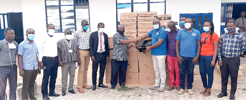 Mr Stepten Adjei (5th right), handing over the computers to Pastor Dr Annor Boafo during the ceremony in Kumasi while other dignitaries look on